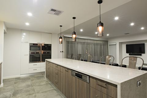 Kitchen and dining area with twin wall ovens and a long island bench