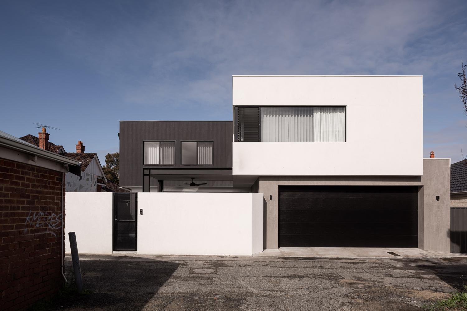 Rendered two-storey street elevation in white and charcoal, with a recessed garage