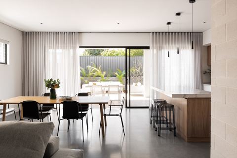 Living and dining area looking out through stacking doors to the alfresco