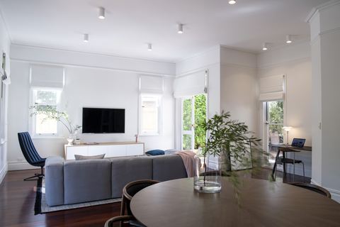 Living and dining space with jarrah floors and windows to the garden on two sides